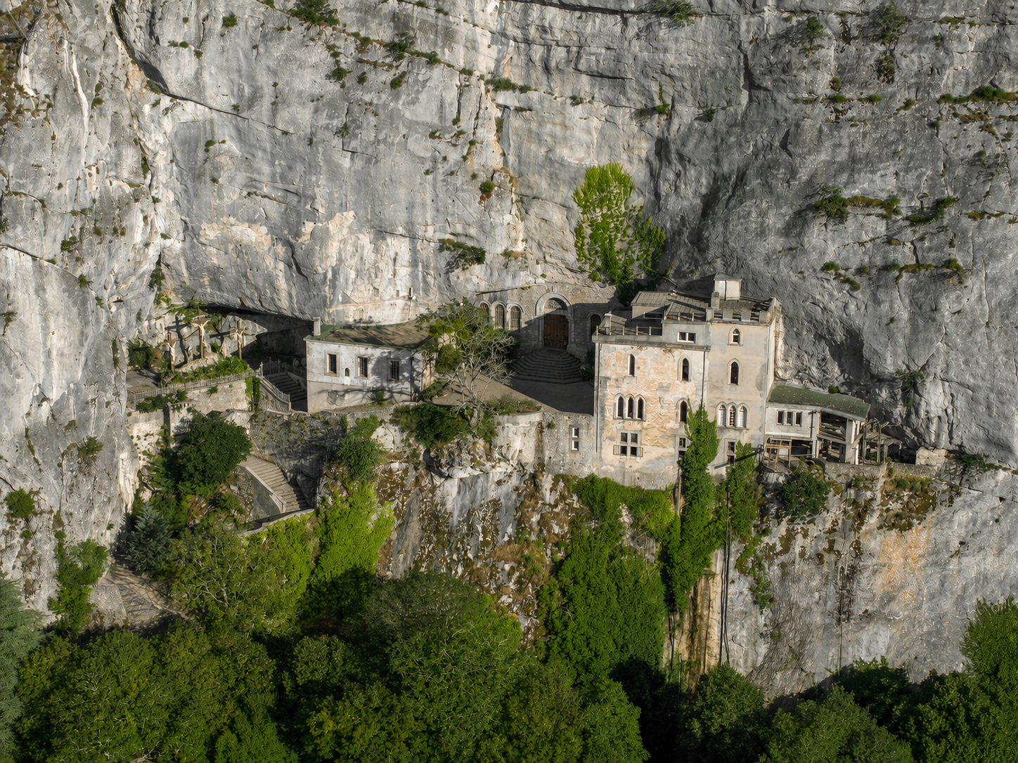The Sainte-Baume grotto and Dominican hôtellerie set into the limestone cliff above the ancient forest